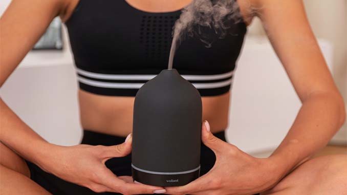 Woman Meditating With A Diffuser
