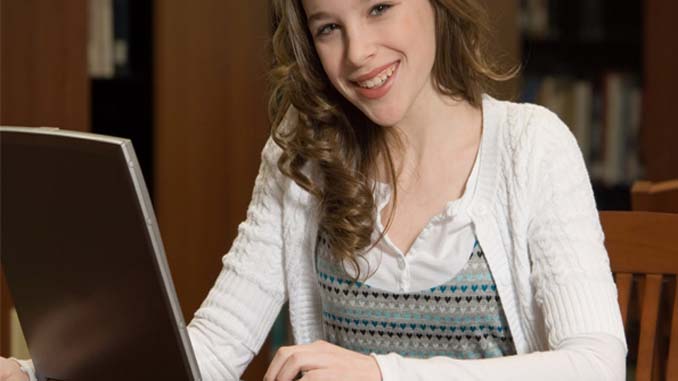 Smiling Woman At Her Laptop