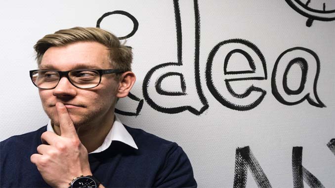 Man Standing In Front Of A White Board Saying "Idea"