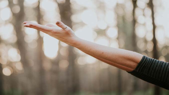Woman With Hand Extended To Heaven