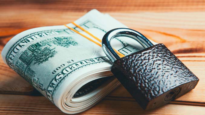 Folded $100 Bills With A Padlock On Top