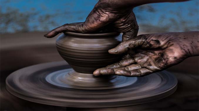 Vase Being Sculpted On A Wheel