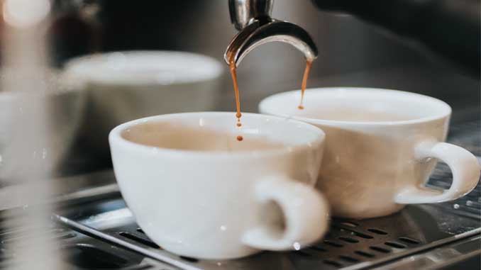 Two Cups Of Espresso Being Poured