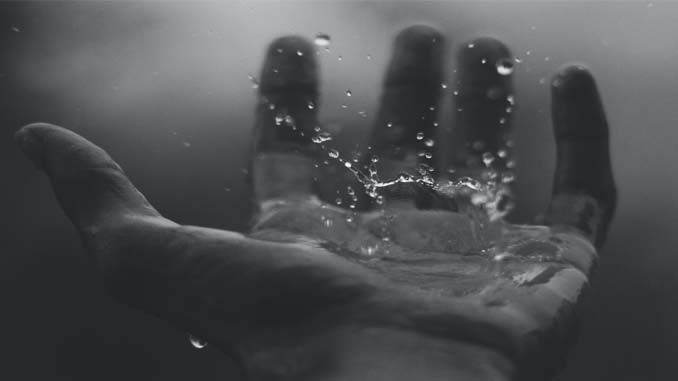 Hand Catching A Drop Of Water