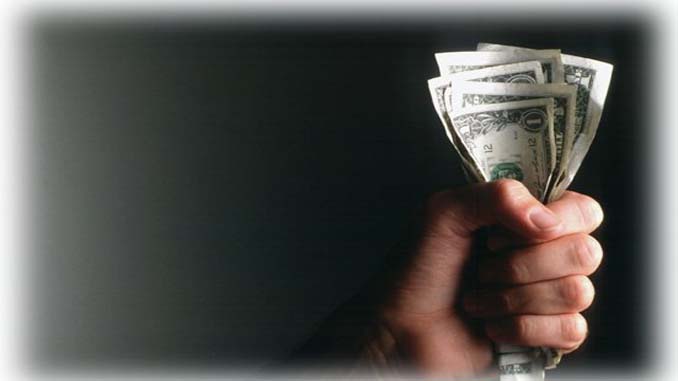Man Holding A Fist Full Of Bills