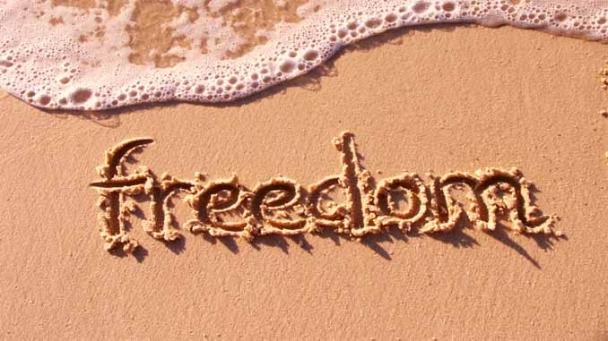 The Word "Freedom" Written In The Sand