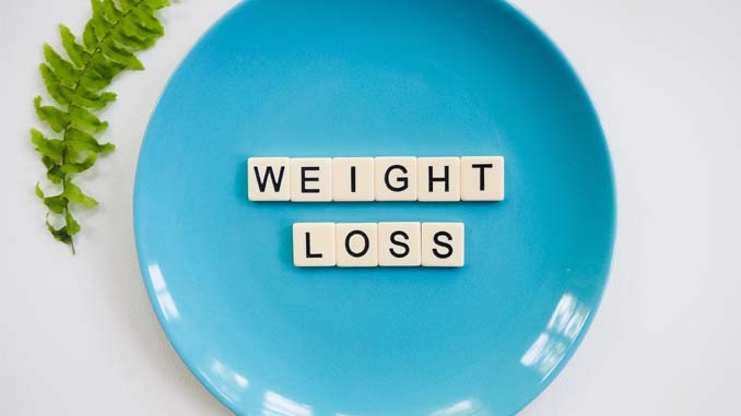 A Plate With Tiles Saying "Weight Loss"