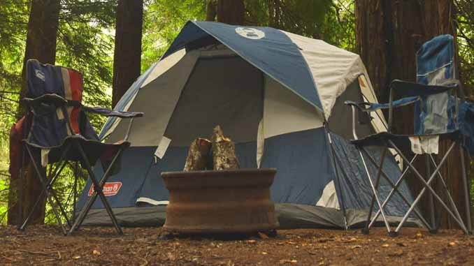 A Campsite, Tent, Chairs And A Firepit
