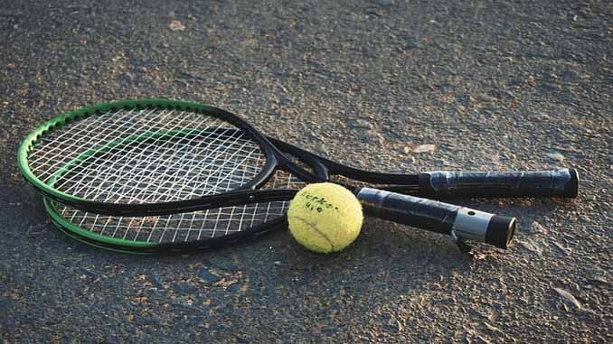 Two Tennis Racquets And A Ball
