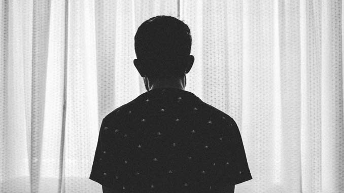 Man Sitting Alone Looking Out The Window