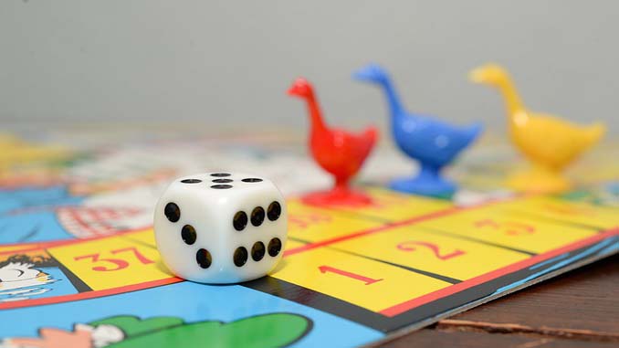 A Playing Board With Pieces And Dice