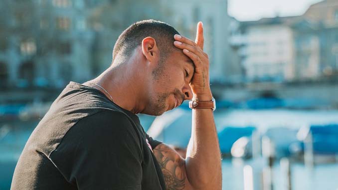 Man In Despair With Head In Hand