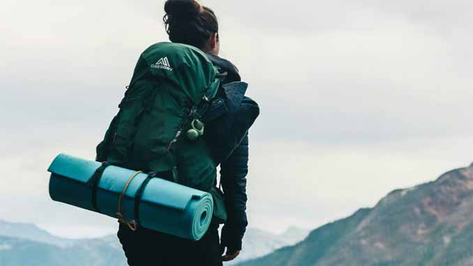 Woman With Camping Gear Taking In The Scenery