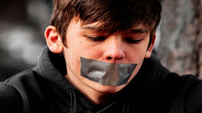 Young Man With Duct Tape Over His Mouth