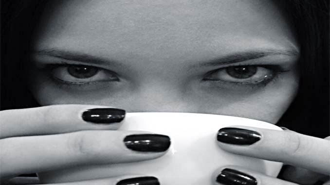 Woman Drinking A Hot Beverage