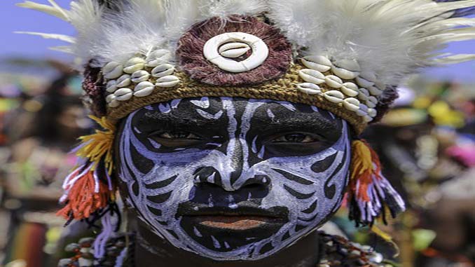 Man In Colorful Ethnic Headdress With A Painted Face