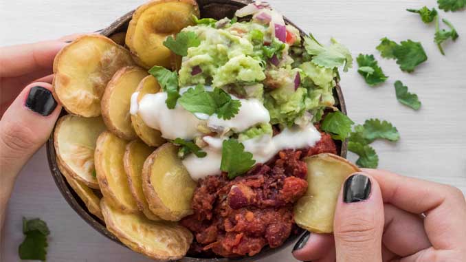 A Bowl With Dips And Fried Potatoes