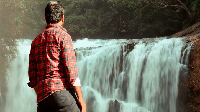 Man Enjoying A Waterfall