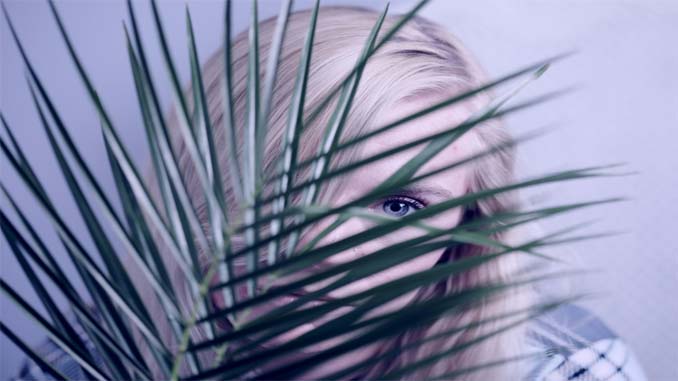 Woman Hiding Behind A Plant