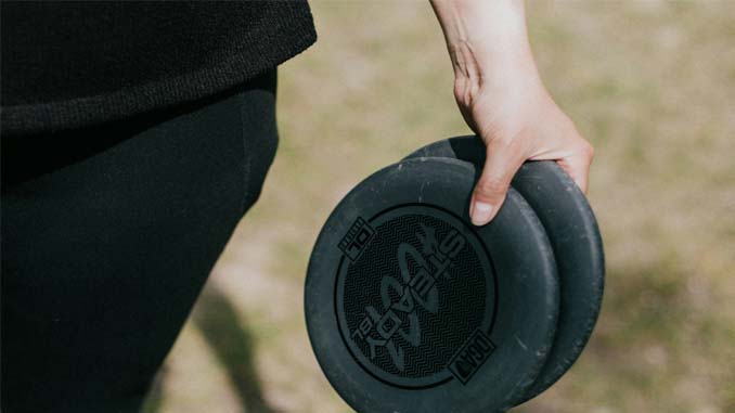 Person Holding Two Frisbees