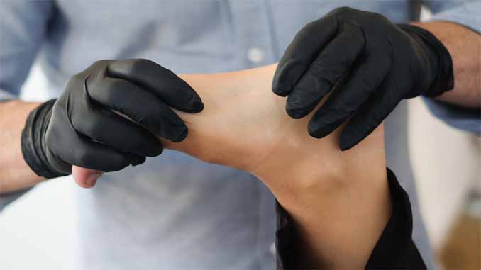 Physiotherapist Working On A Patient