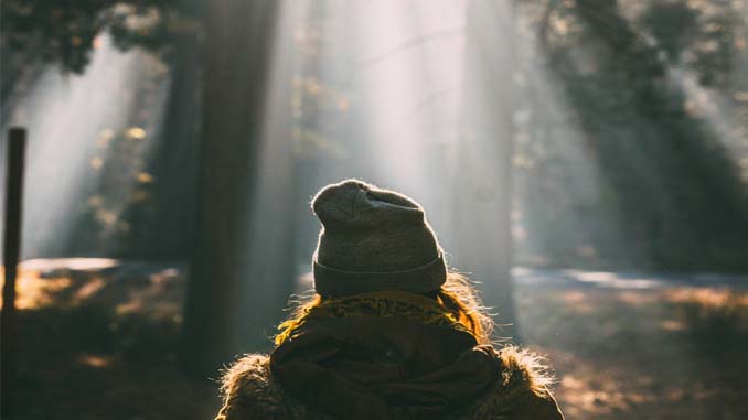 Woman In The Forest With The Suns Rays Coming Down