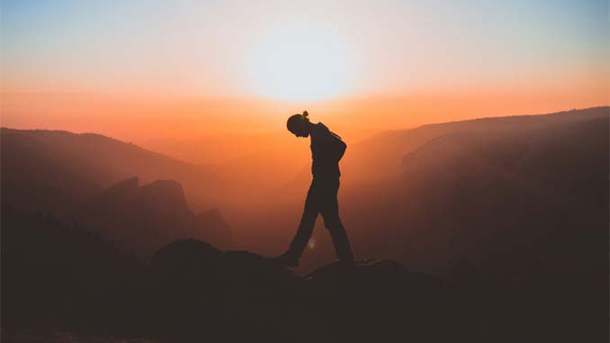 Man Walking On The Rocks At Sunset