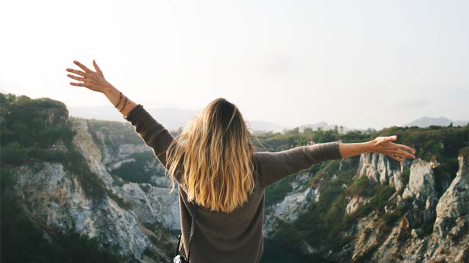 Woman With Outstretched Arms In The Mountains