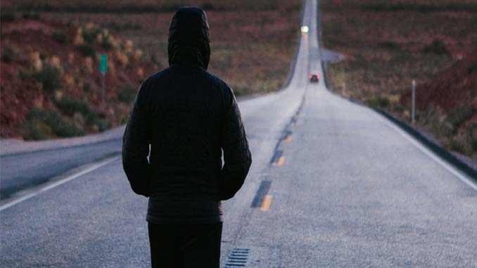 Person Walking Down The Center Of A Highway