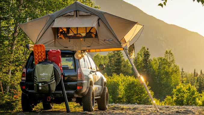 An SUV With A Tent On The Roof