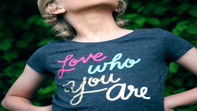 Young Girl Wearing Shirt Saying "Love Who You Are"