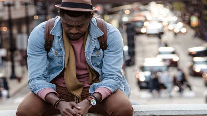 Sad Man Sitting On A Ledge