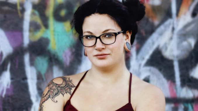 Woman Standing In Front Of A Colorful Wall