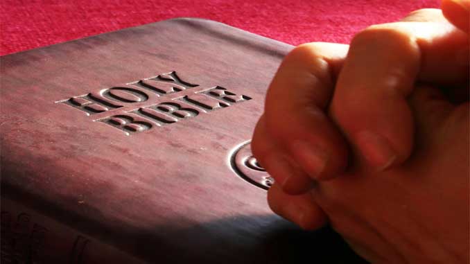 Praying Hands On A Bible