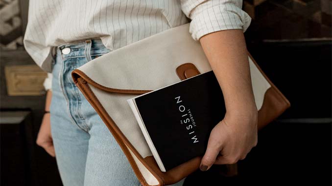 Woman Carrying Her Bag And A Journal