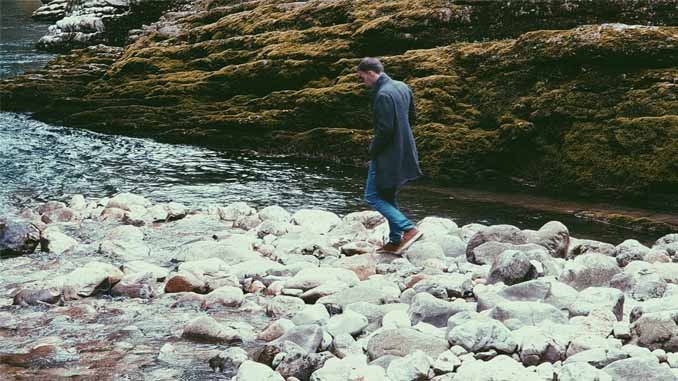 Man Walking Alone Along The River