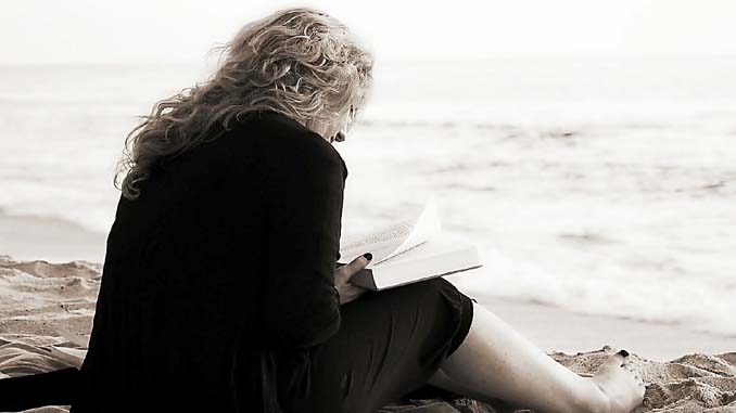 Woman Reading On The Beach