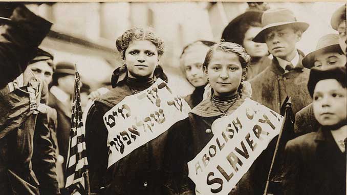 Black And White Of Children Wearing Sashes Reading "Abolish Slavery"