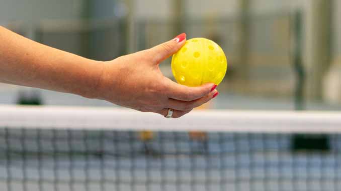 Woman Holding A Pickleball Ball