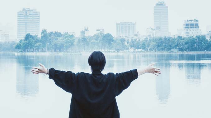 Woman With Outstretched Arms Overlooking Lake