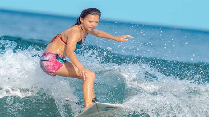 Young Woman Riding The Waves