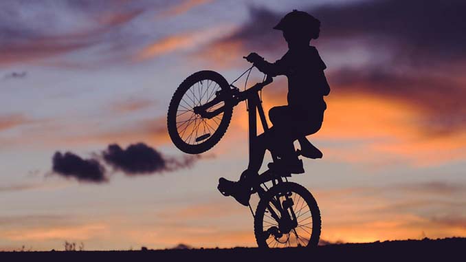 Boy On Bike At Sunset