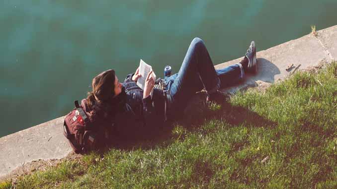 Woman Reading By The Water