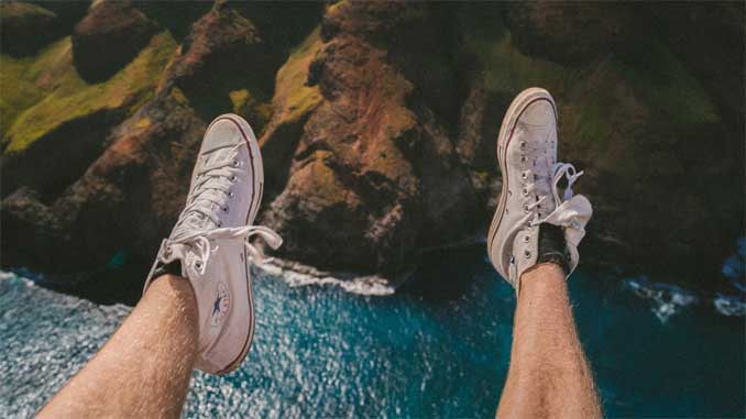 Man Sitting On A Cliff