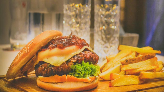 A Burger, Fries And Water Glasses