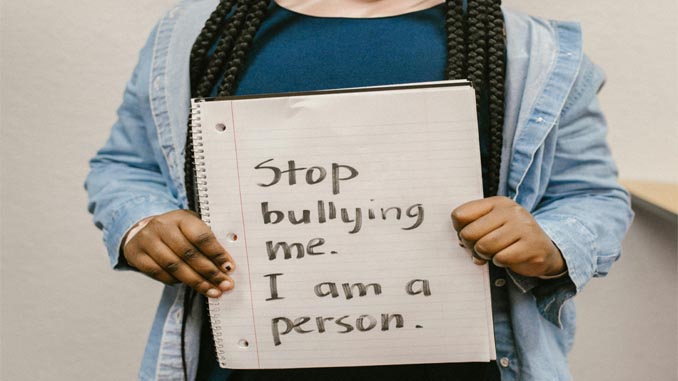 Child Holding A Stop Bullying Sign