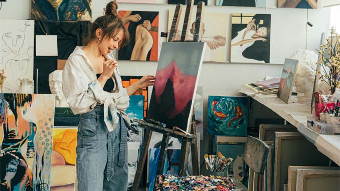 Woman Standing By Her Painting