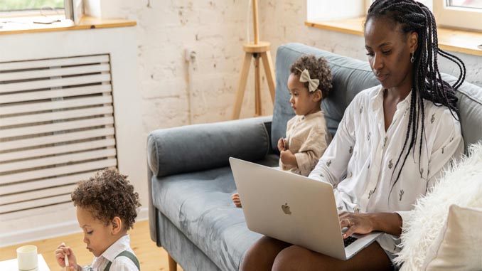 Mother On Laptop With Her Kids